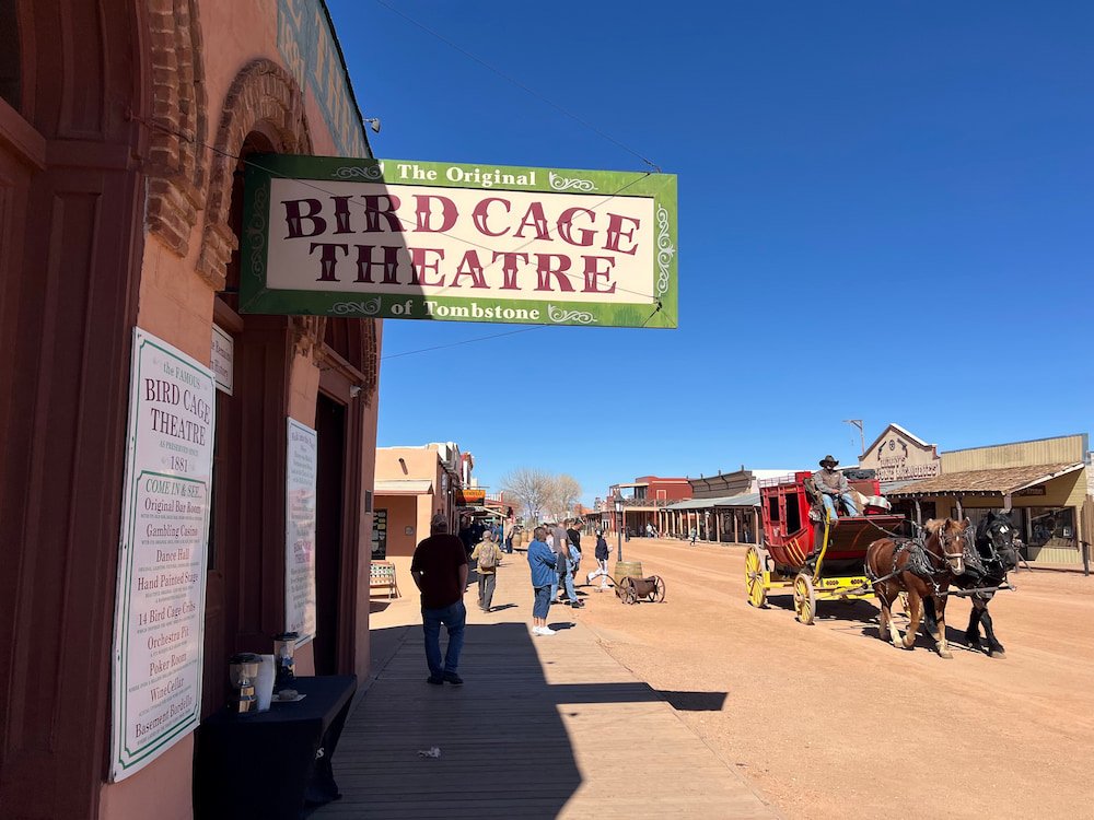A horse-drawn carriage passes the Birdcage Theater
