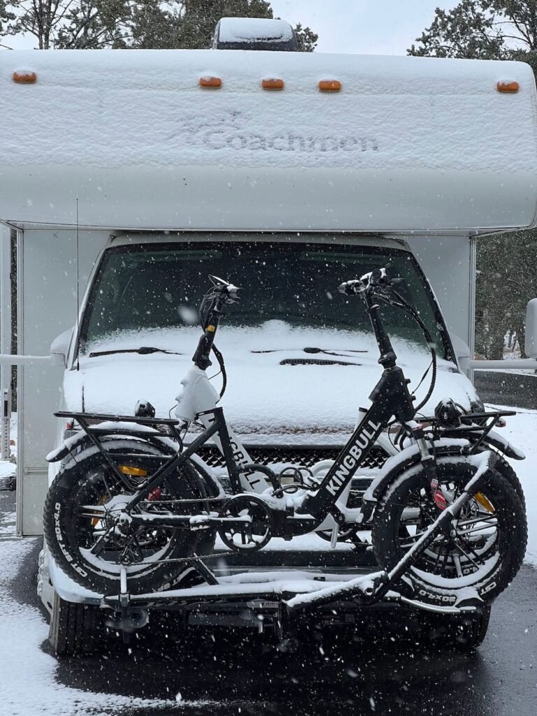 The RV getting covered in snow as it falls