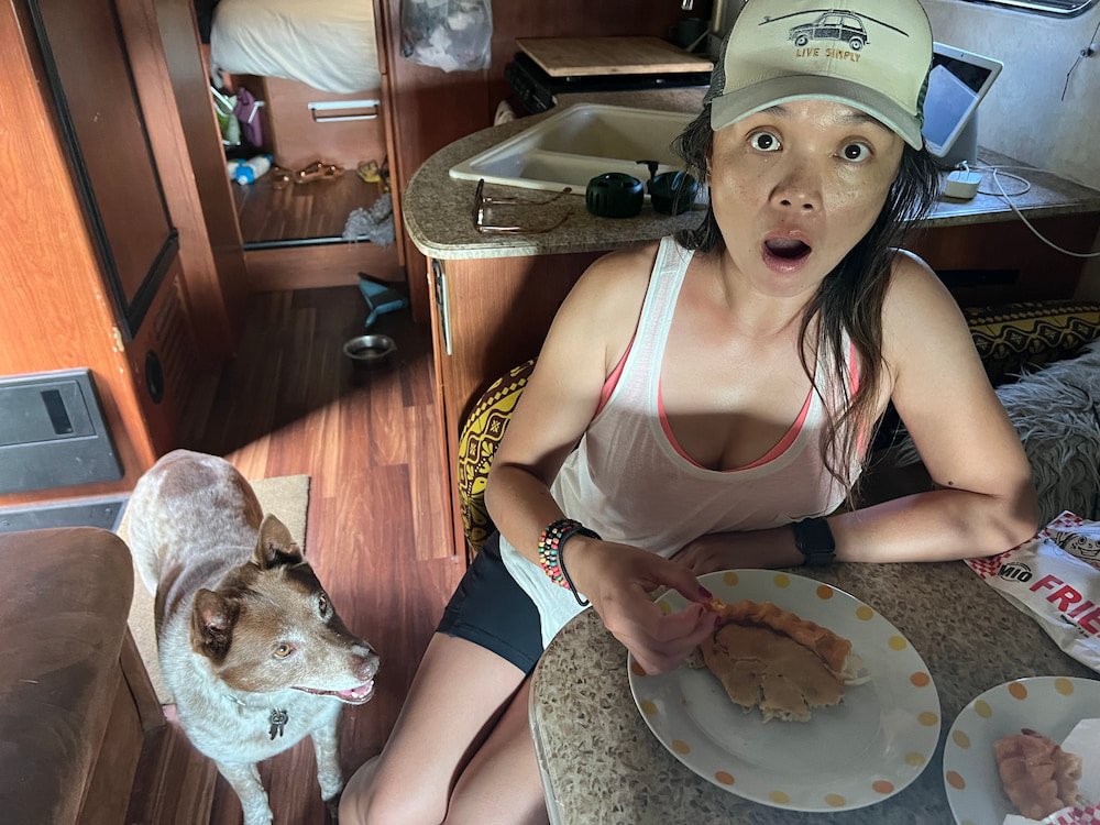 Lisette digging into the pies while Sheila looks on expectantly