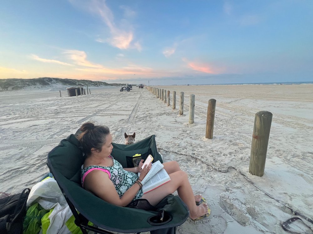 Lisette reading with a nice sunset