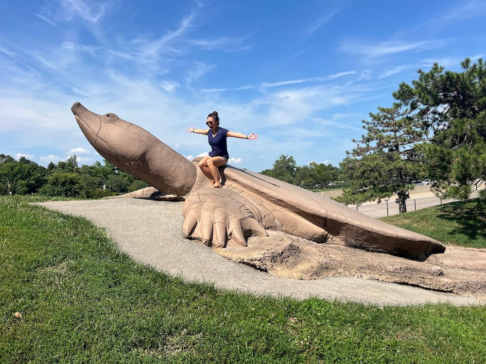 Lisette riding a giant turtle
