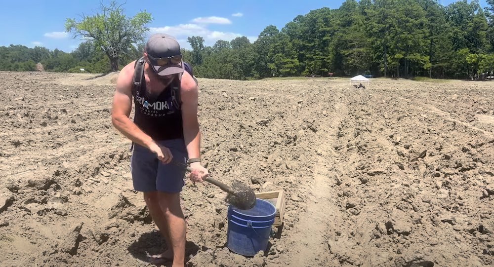 Michael digging up some soil to screen
