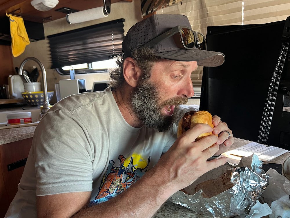 Michael eating his sandwich which was jam-packed