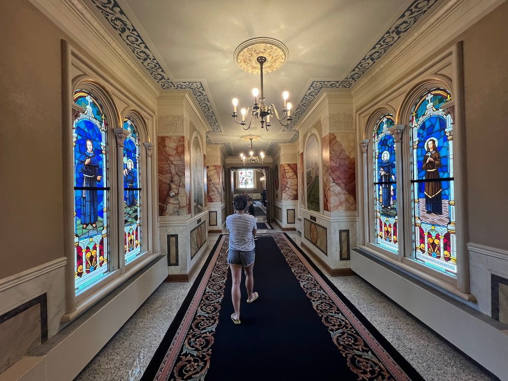 Lisette walking through the stained glass corridor