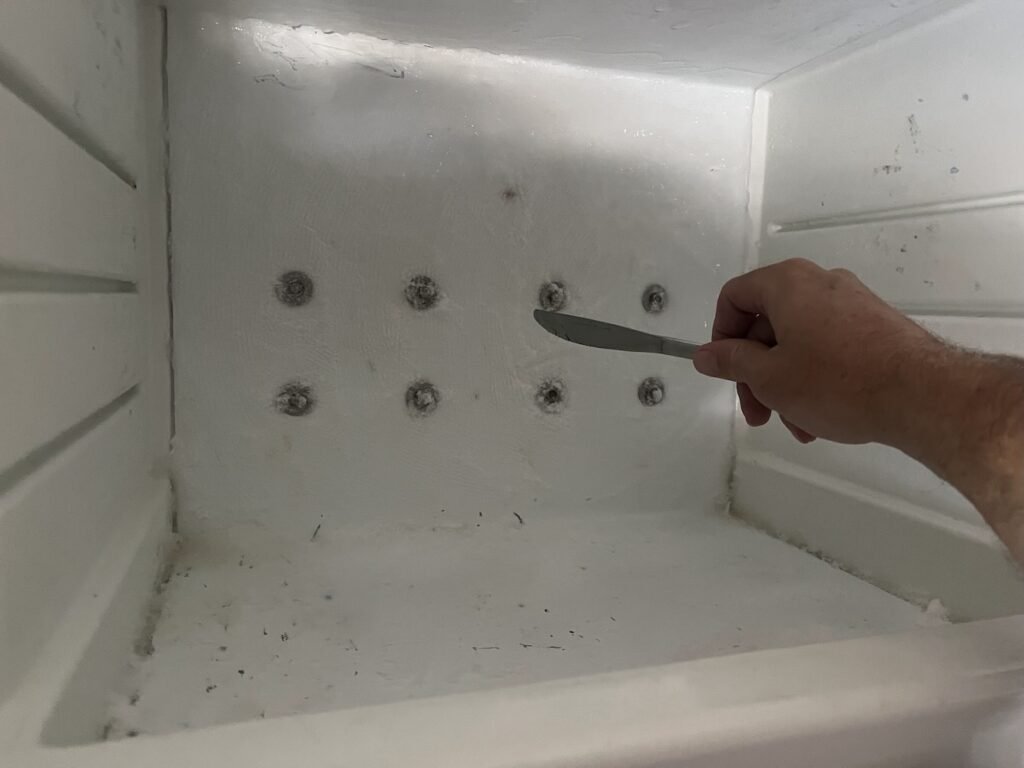 Scraping the ice formed in our freezer