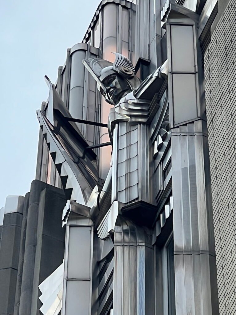 Figure at the top of the building