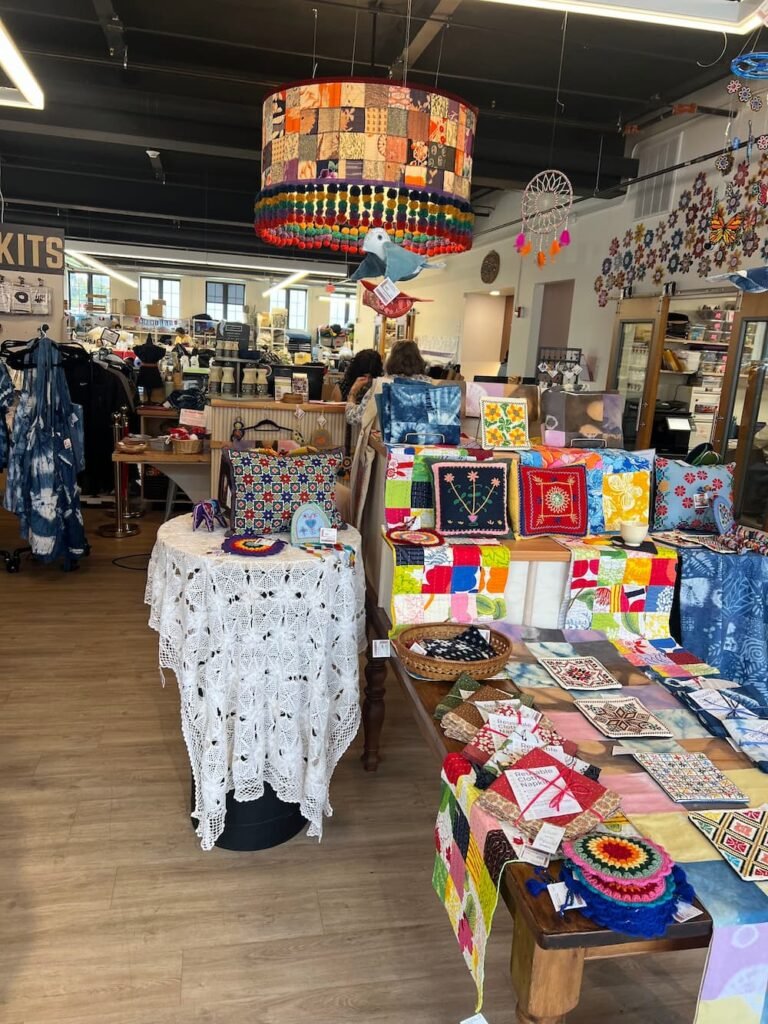 Inside the small shop with the workers out the back