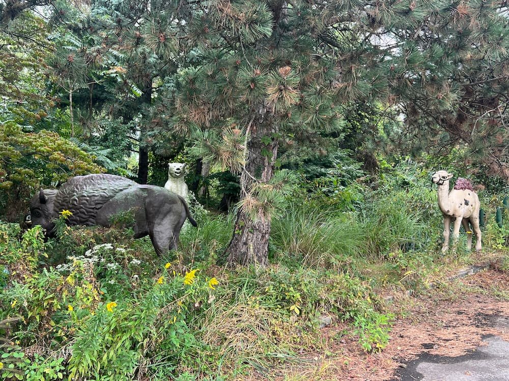 Some of the animal statues in the overgrown garden