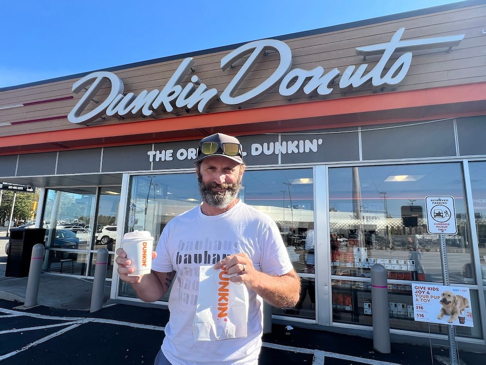 Michael with his donut and coffee at the Original Dunkin