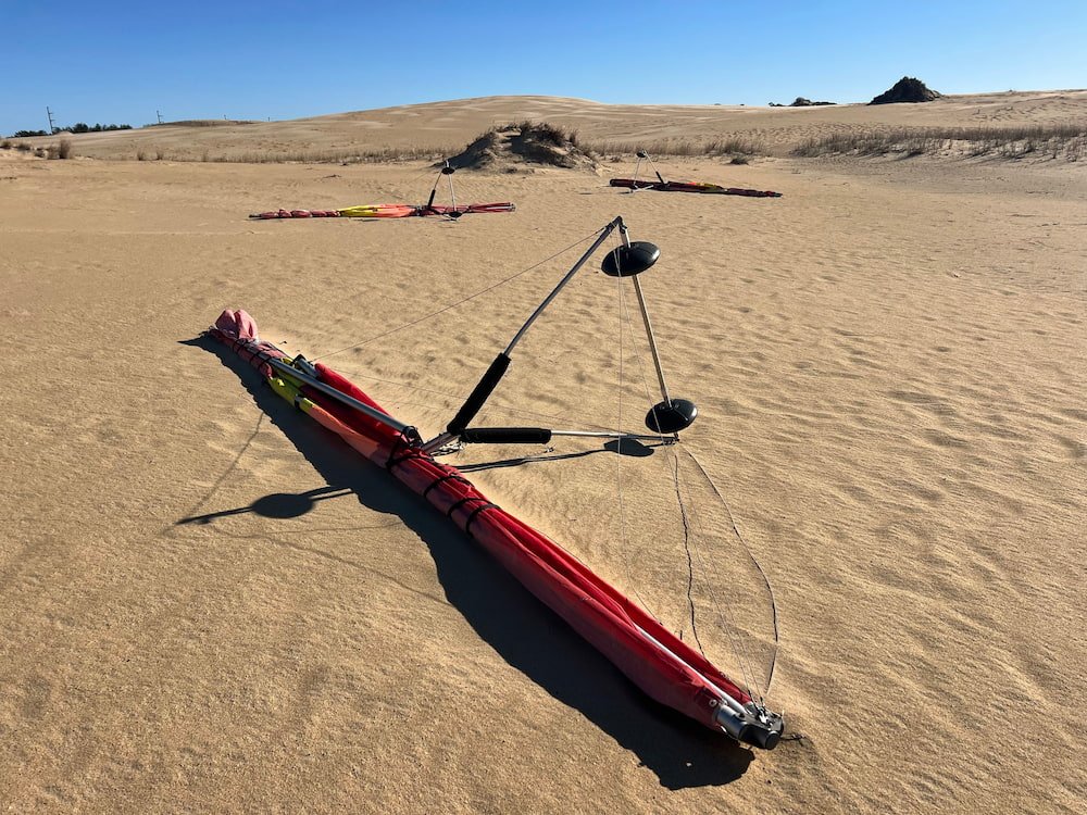 Hang gliders just left at the dunes with no one around