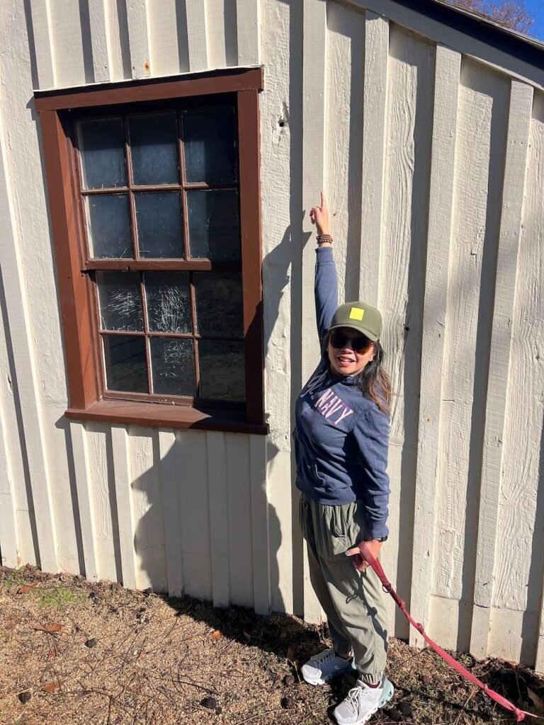 Lisette points out one of the many bullet holes in Innis House